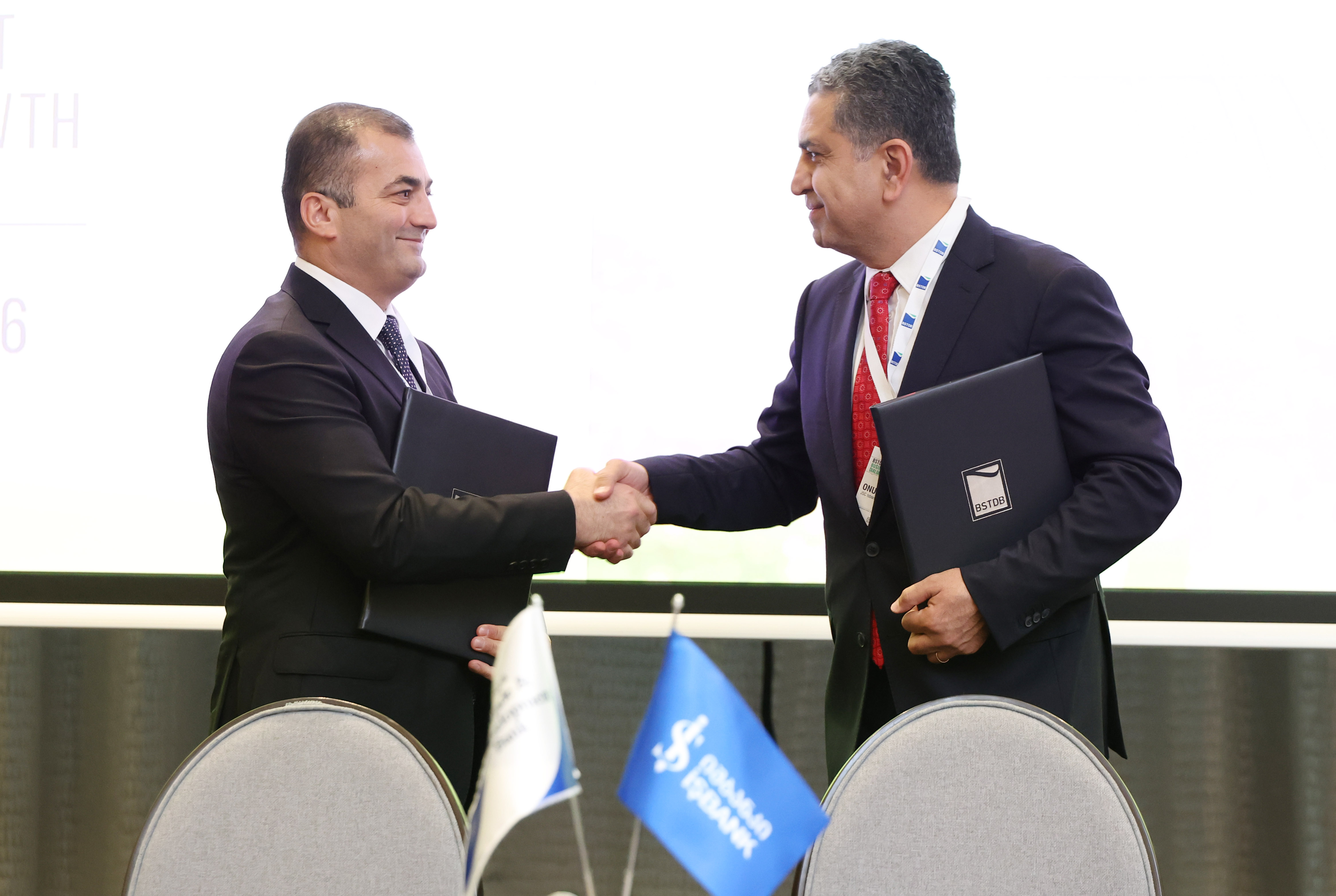 BSTDB Vice President Banking Ziya Aliyev and Isbank Georgia CEO Onur Kutuk shake hands after signing the EUR 7 million SME financing agreement in Tbilisi.